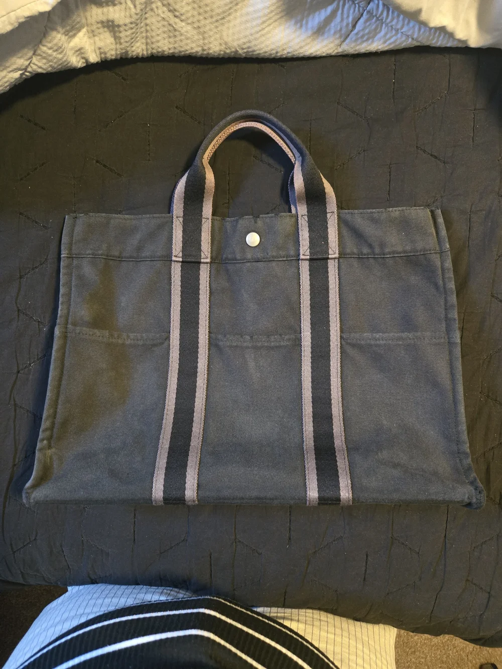 Hermès Fourre Tout canvas tote bag, featuring striped handles and a snap closure